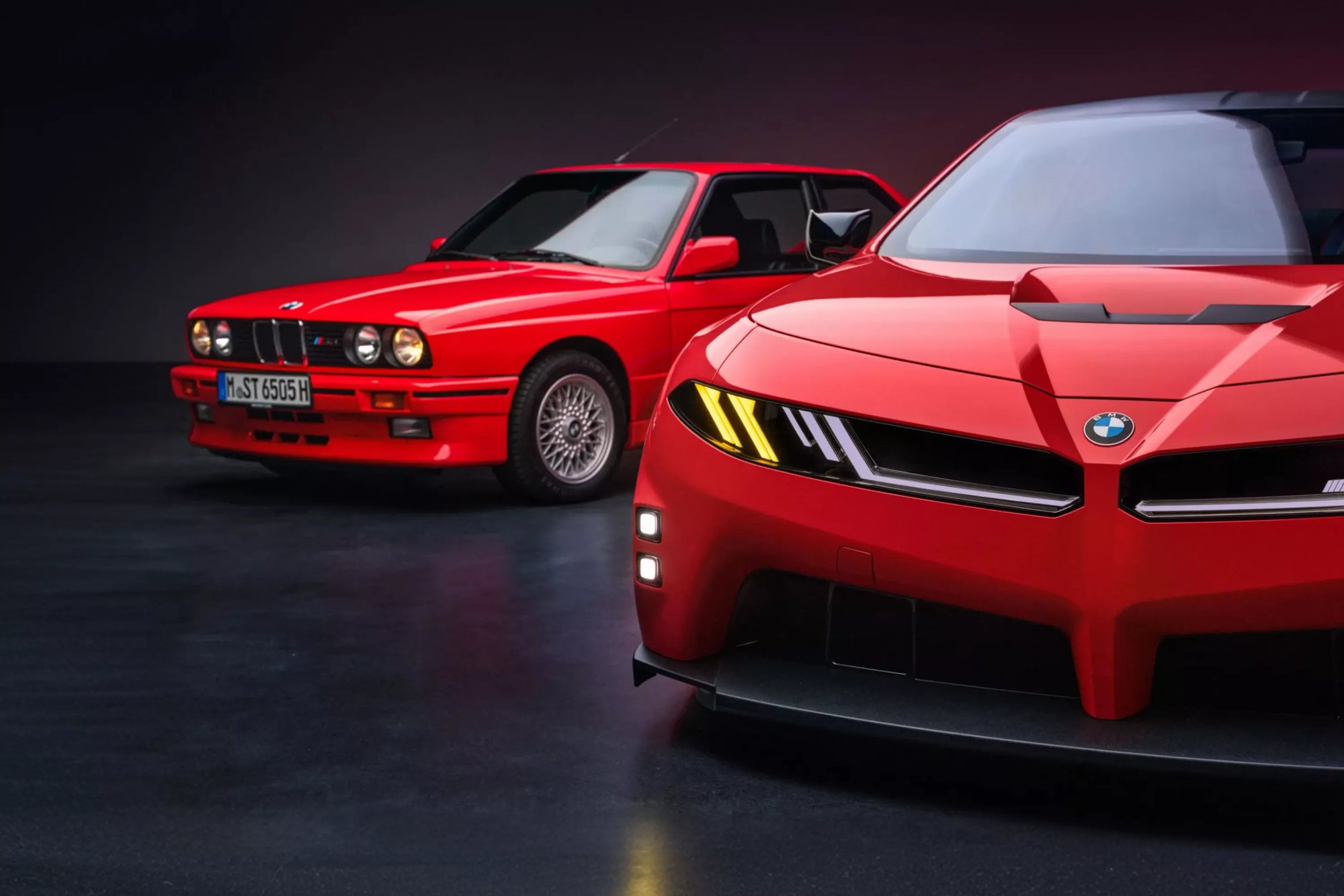 The BMW M Concept Neue Klasse in red, the E30 M3 behind it